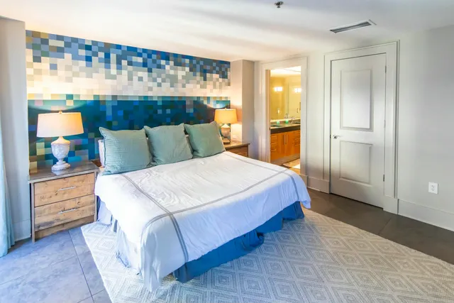 a bedroom with a bed and a painting on the wall