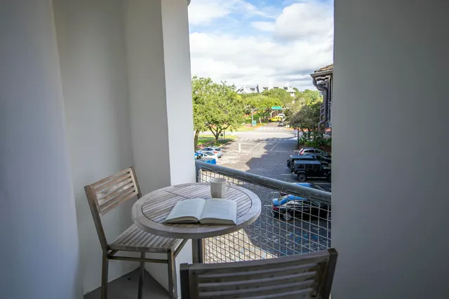 a dining room with furniture and a floor to ceiling window