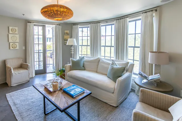 a living room with furniture a table and a window