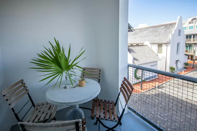a view of a livingroom with furniture and a potted plant