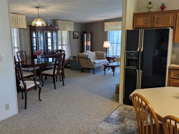 a living room with furniture a dining table and chairs