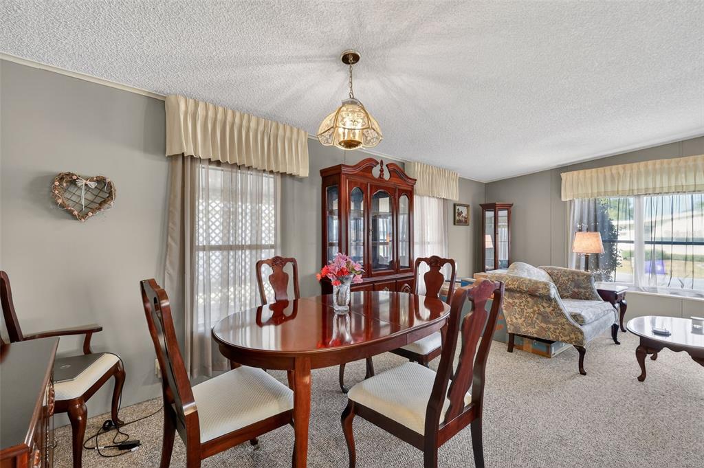 3211 Wekiva Road Tavares, FL 32778 - Photo 20 of 39 a dining room with furniture a chandelier and window