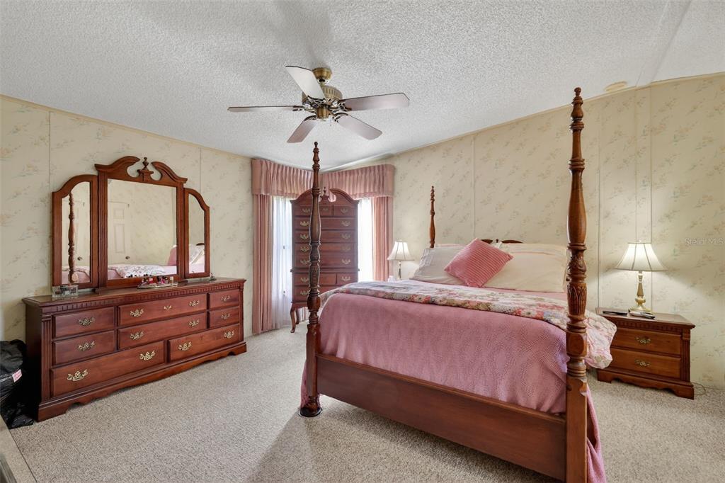 3211 Wekiva Road Tavares, FL 32778 - Photo 22 of 39 a bedroom with a bed and a dresser