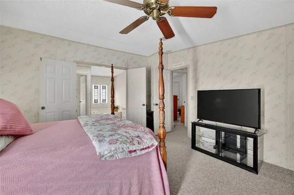 a bedroom with a bed and a flat screen tv