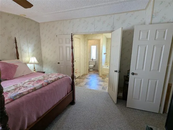 a bedroom with a bed and a mirror