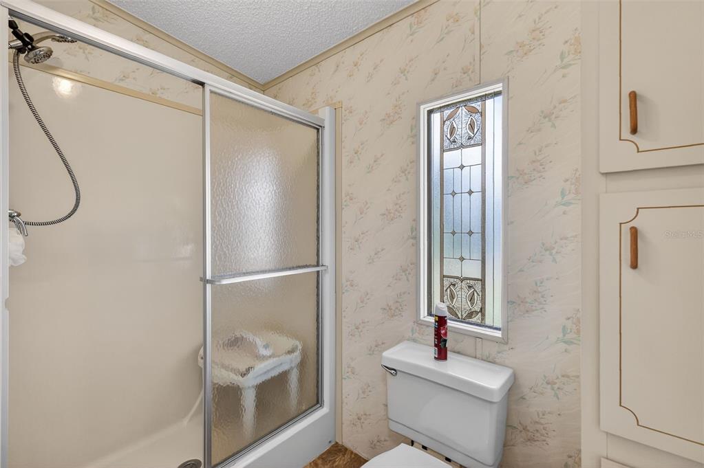 3211 Wekiva Road Tavares, FL 32778 - Photo 27 of 39 a bathroom with a shower sink vanity and toilet