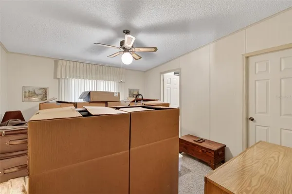 a room with furniture and a ceiling fan
