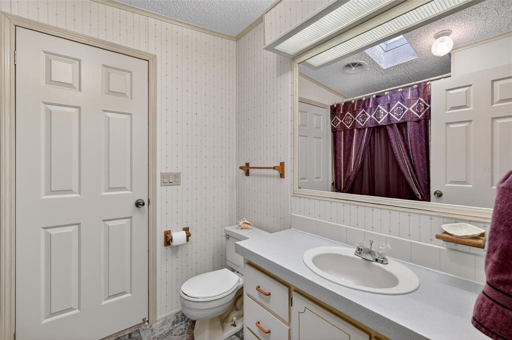 3211 Wekiva Road Tavares, FL 32778 - Photo 29 of 39 a bathroom with a sink a toilet and shower curtain