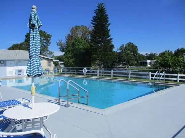 a view of a swimming pool with a table and chairs
