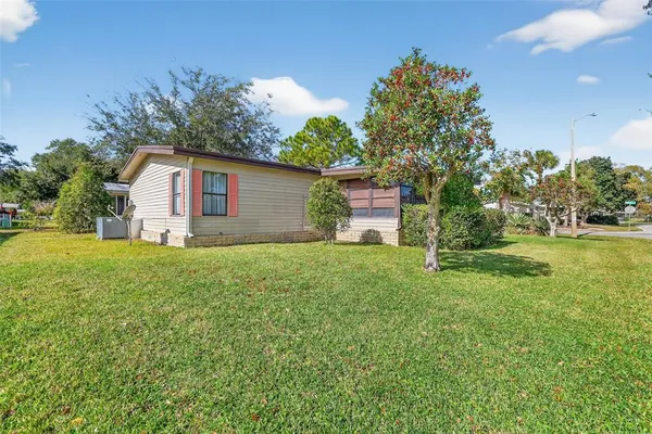 a front view of house with yard and trees