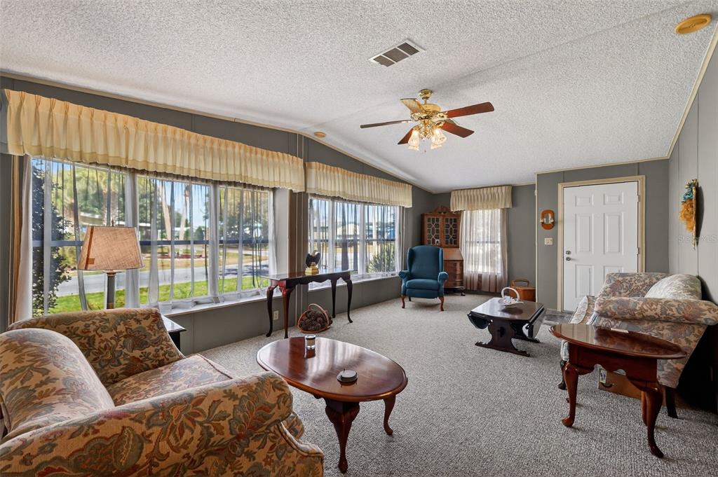 3211 Wekiva Road Tavares, FL 32778 - Photo 8 of 39 a living room with furniture and a large window