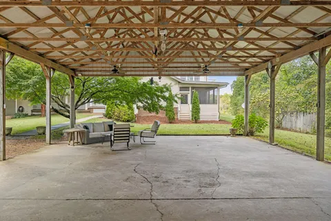 a view of balcony with wooden floor and fence