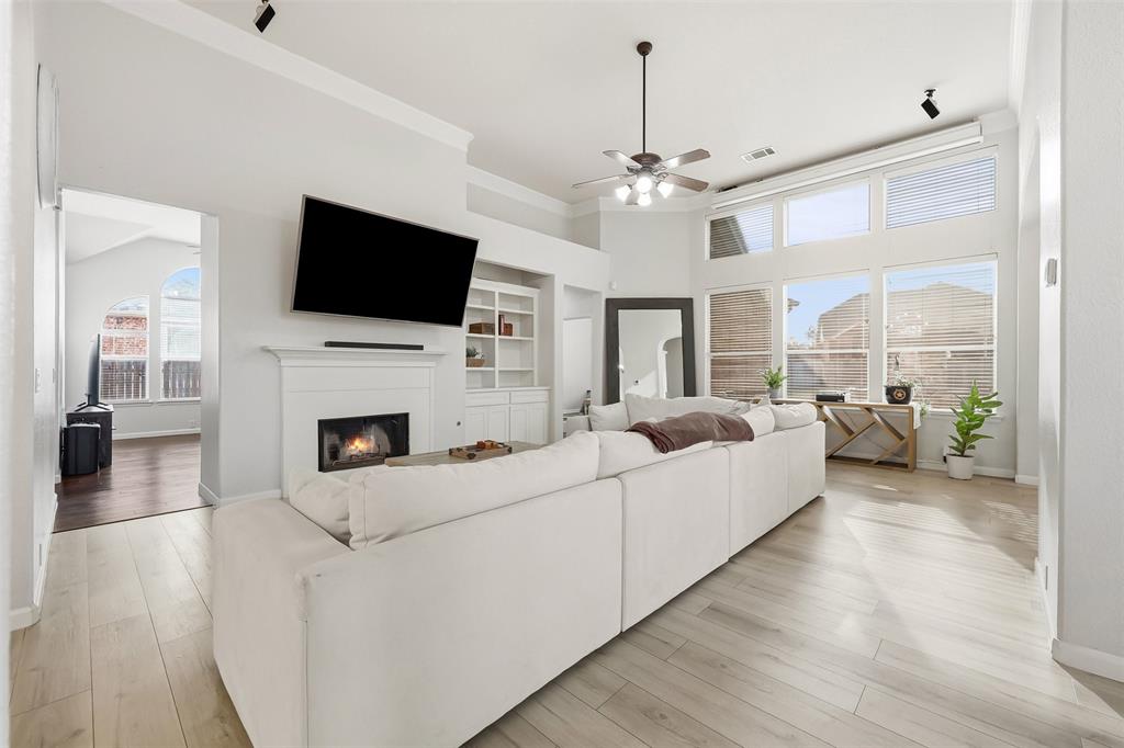 1801 Rim Rock Trail Mansfield, TX 76063 - Photo 13 of 40 a living room with furniture a fireplace and a flat screen tv