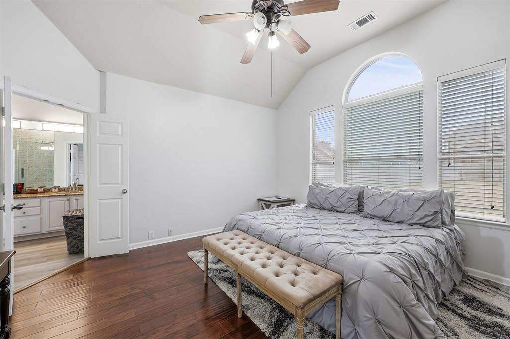 1801 Rim Rock Trail Mansfield, TX 76063 - Photo 18 of 40 a bedroom with a bed and a chandelier