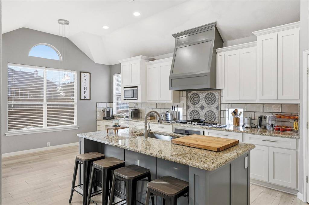 1801 Rim Rock Trail Mansfield, TX 76063 - Photo 4 of 40 a kitchen with granite countertop a sink a stove and cabinets