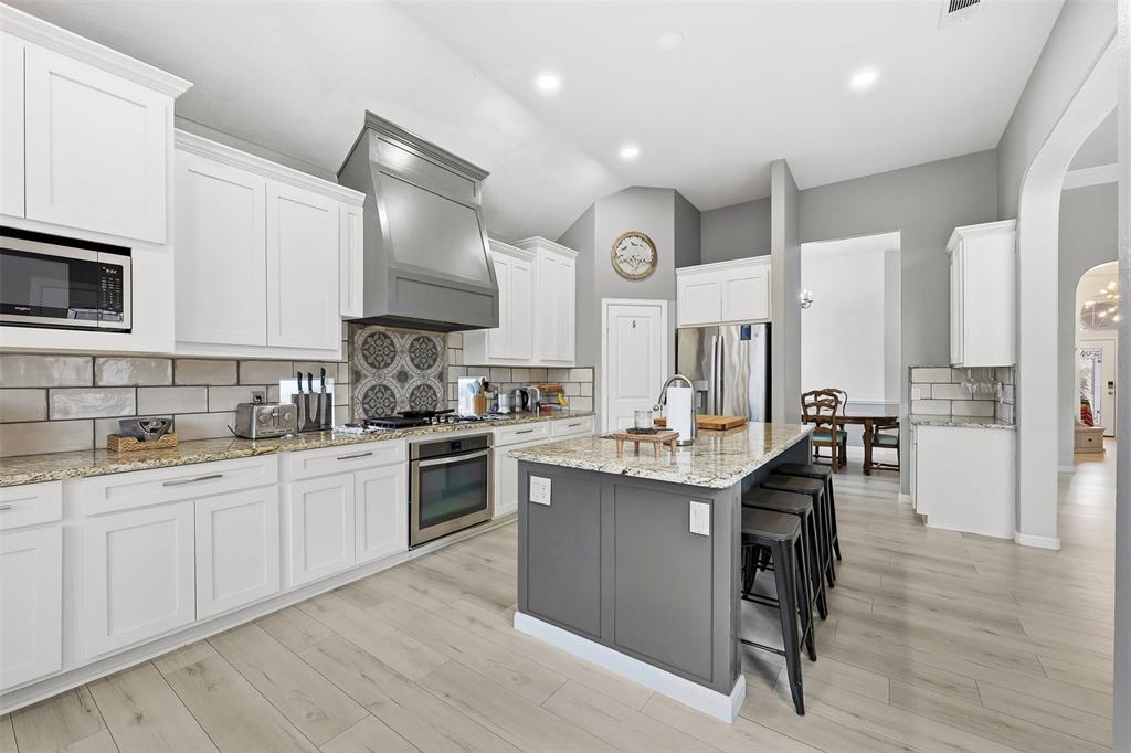 1801 Rim Rock Trail Mansfield, TX 76063 - Photo 5 of 40 a kitchen with stainless steel appliances granite countertop a sink stove and refrigerator