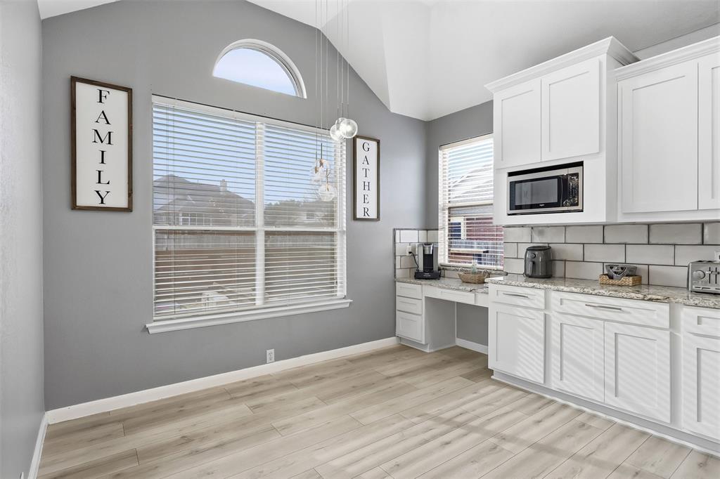 1801 Rim Rock Trail Mansfield, TX 76063 - Photo 6 of 40 a kitchen with stainless steel appliances granite countertop a stove a sink and white cabinets