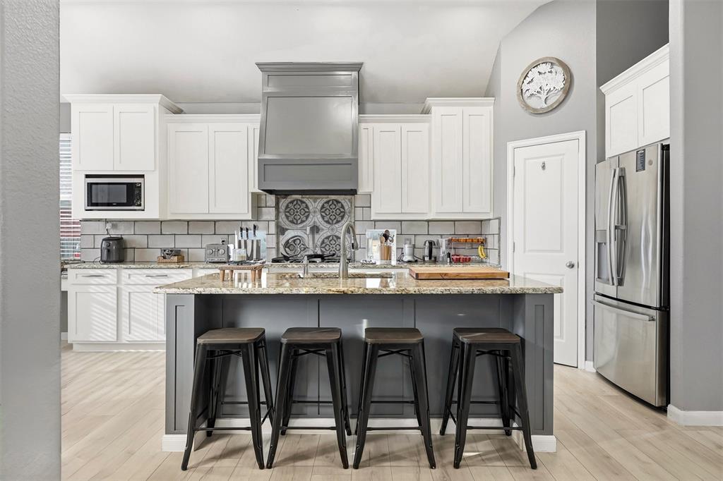 1801 Rim Rock Trail Mansfield, TX 76063 - Photo 9 of 40 a kitchen with stainless steel appliances granite countertop a sink and a refrigerator