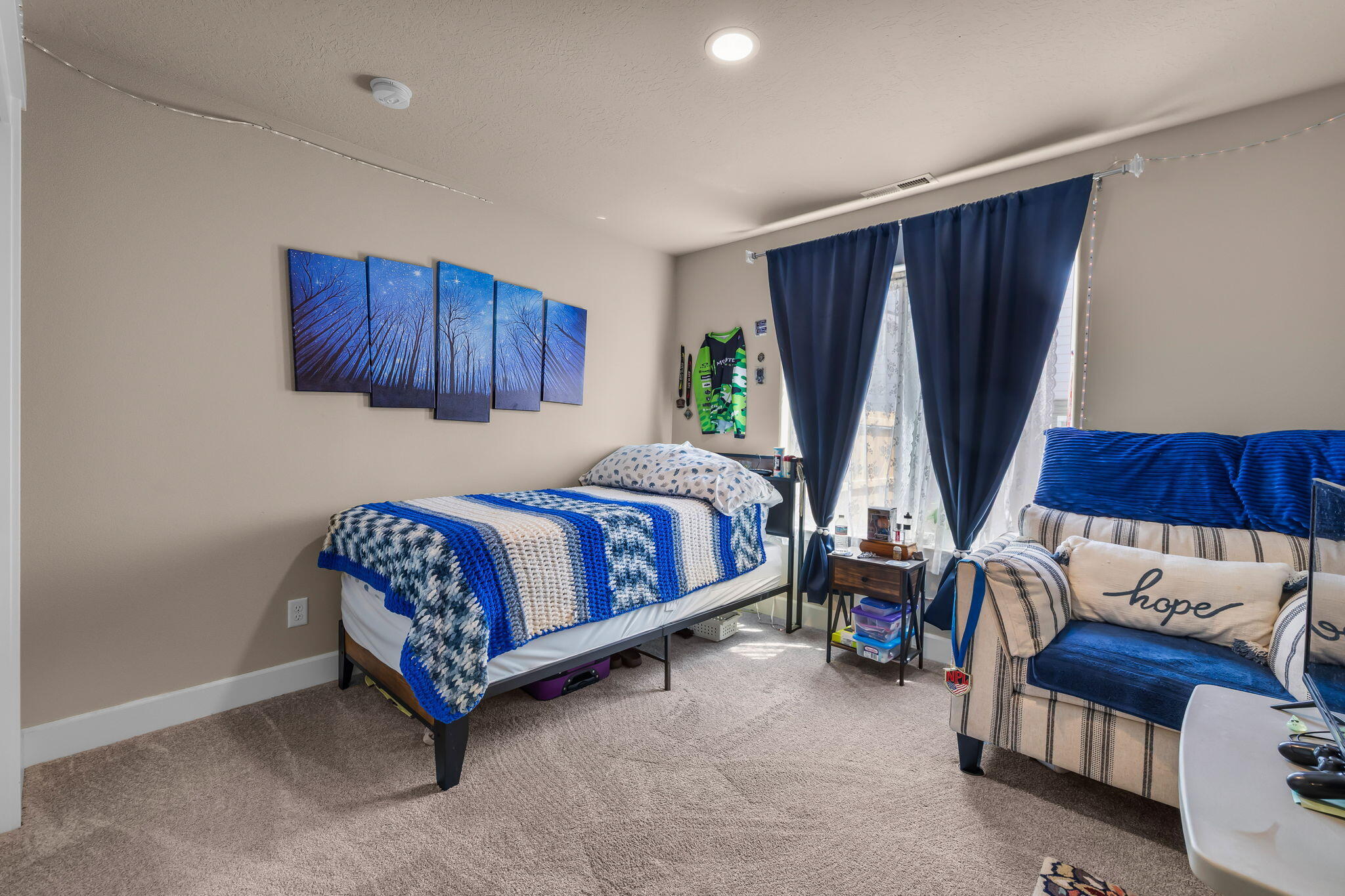 1132 Northwest Golf Course Drive Madras, OR 97741 - Photo 20 of 36 a bed sitting in a room next to a window and a couch