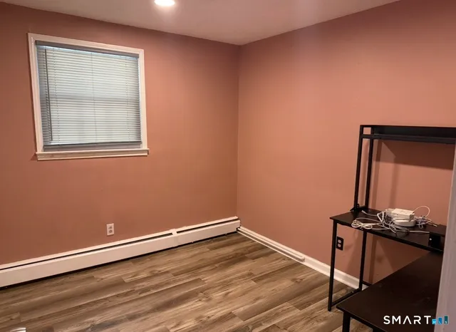 a view of a room with wooden floor and fan