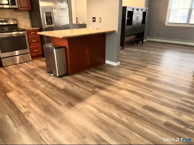 a kitchen with stainless steel appliances granite countertop a sink and a stove