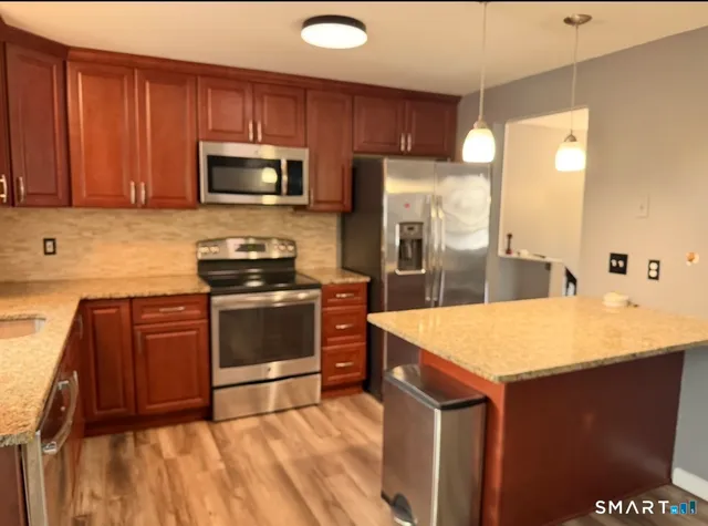 a kitchen with a sink a stove and refrigerator