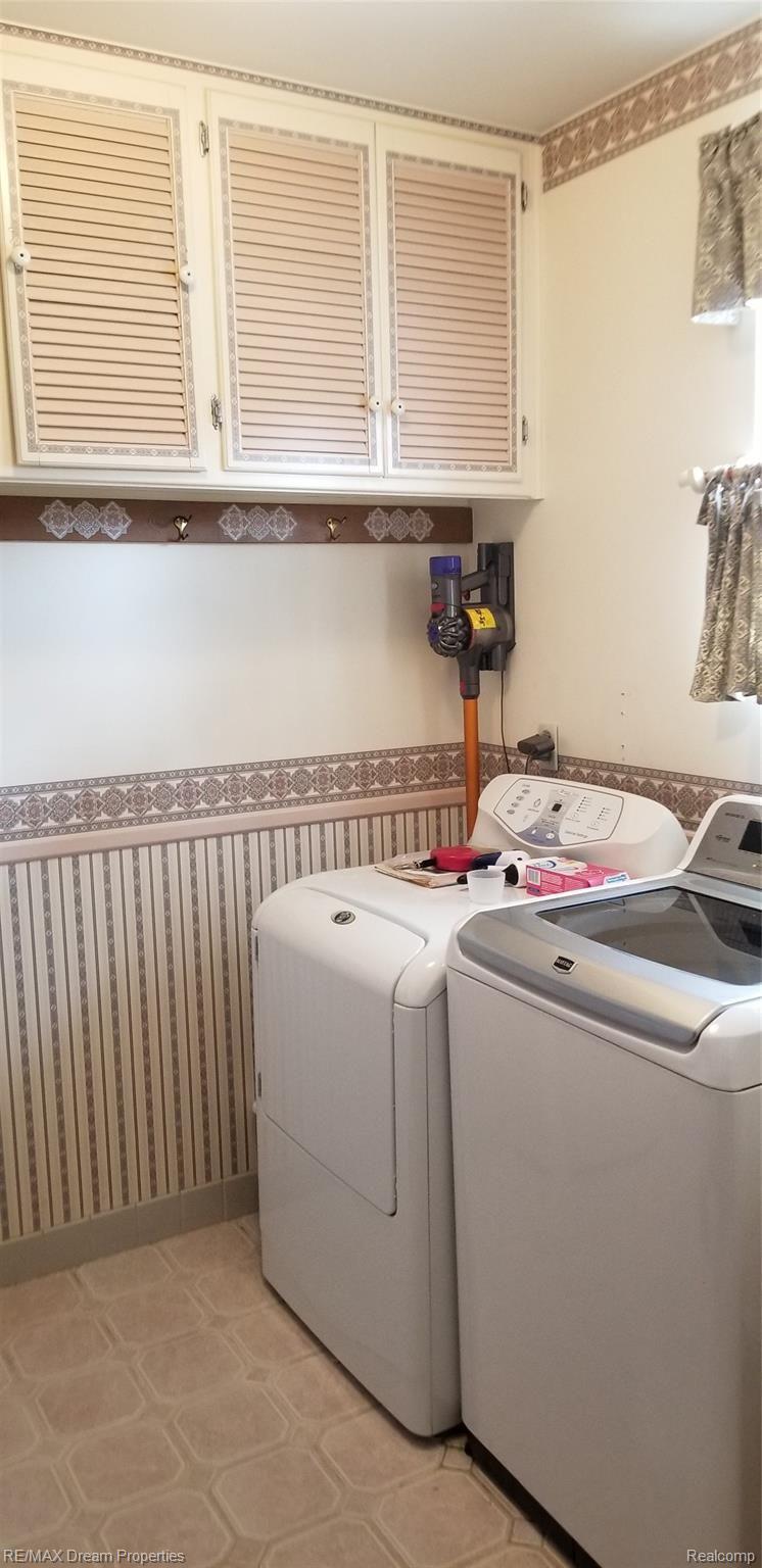 6533 Flintlock Ridge Utica, MI 48317 - Photo 14 of 53 EXTRA LARGE FIRST FLOOR LAUNDRY WITH STORAGE CABINETS / LAUNDRY SINK / CERAMIC TILED FLOORS