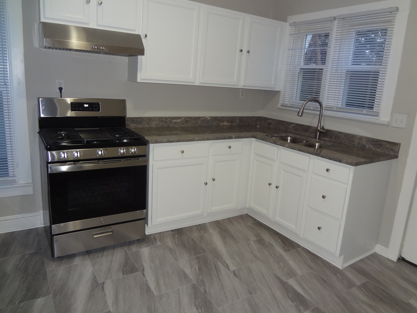 835 Oak Street Elgin, IL 60123 - Photo 23 of 45 a kitchen with granite countertop white cabinets and white appliances