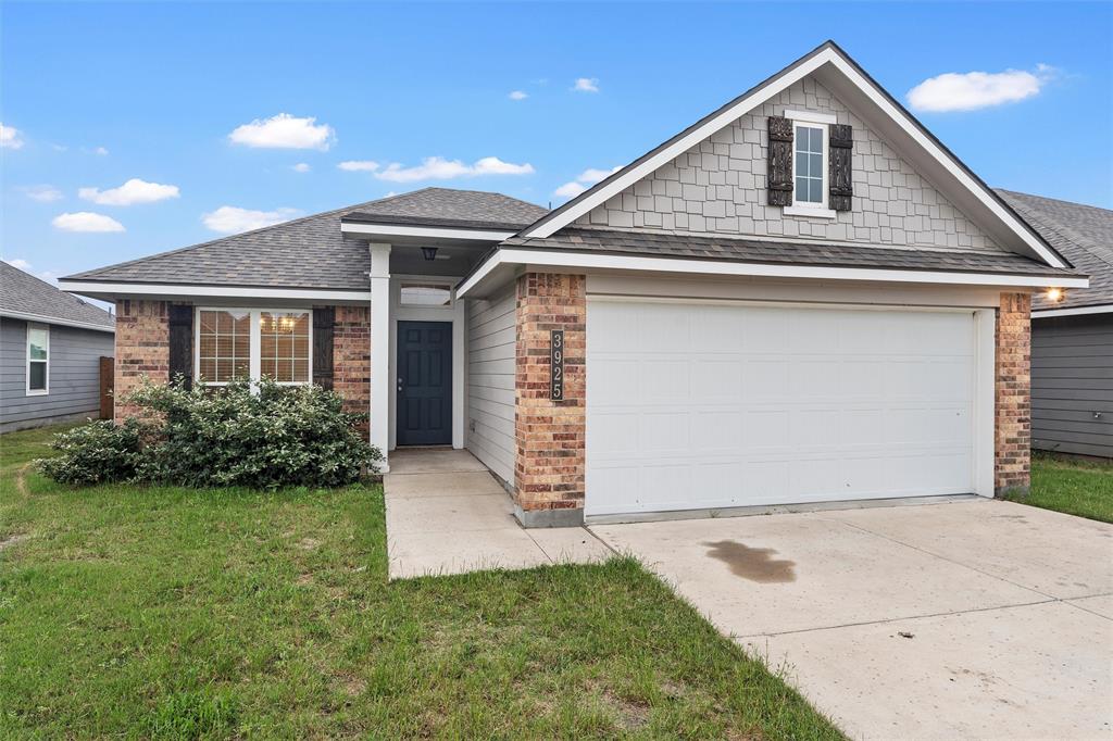 a front view of house with yard and garage