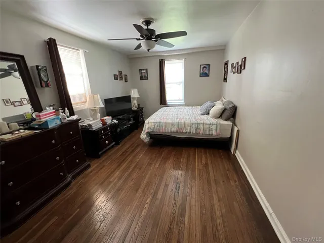 a bedroom with a bed and a flat tv screen on dresser