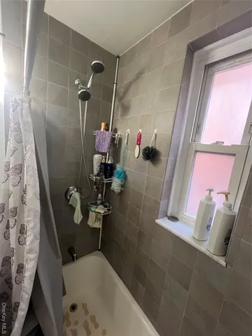 a bathroom with a tub and a shower