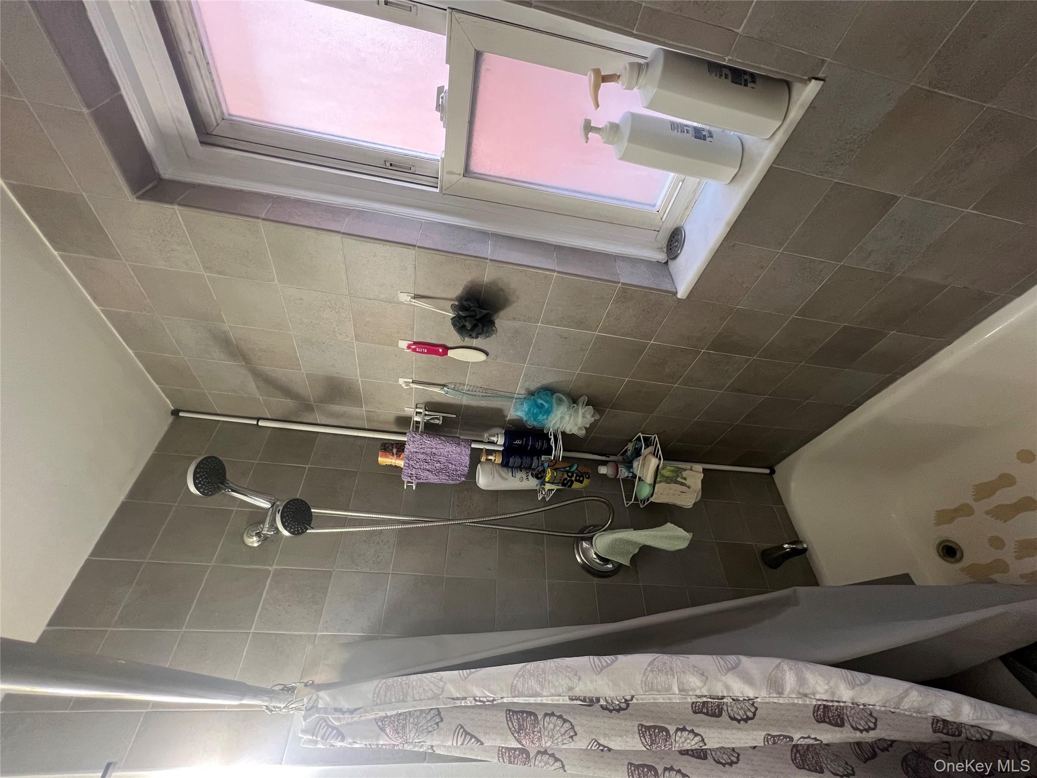 2080 Barnes Avenue, Unit 4C Bronx, NY 10462 - Photo 15 of 17 a bathroom with a tub and a shower