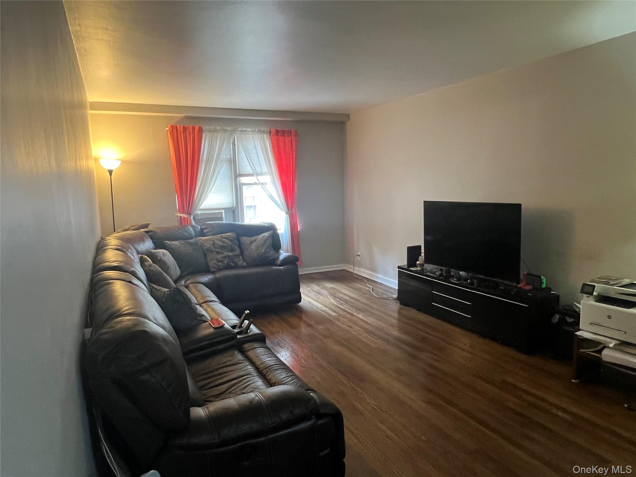 2080 Barnes Avenue, Unit 4C Bronx, NY 10462 - Photo 2 of 17 a living room with furniture and a flat screen tv