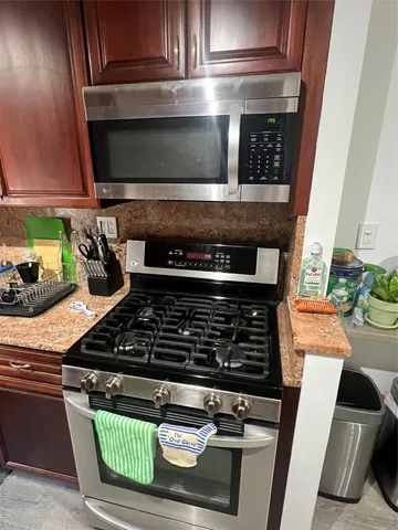 a stove top oven sitting inside of a kitchen