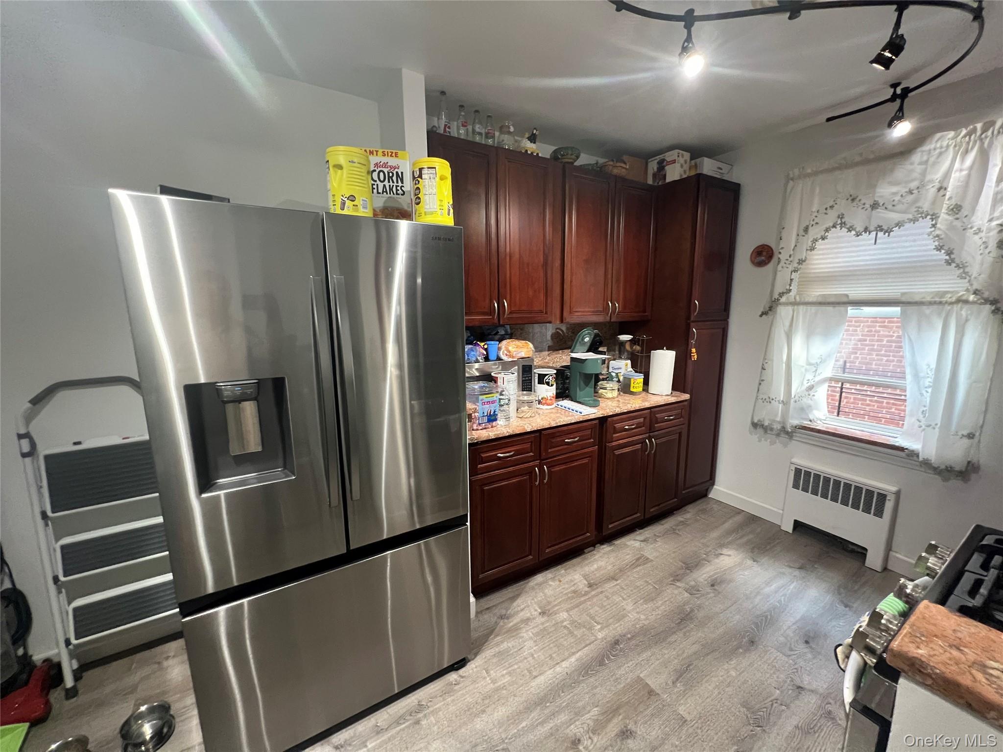 2080 Barnes Avenue, Unit 4C Bronx, NY 10462 - Photo 8 of 17 a kitchen with stainless steel appliances granite countertop a refrigerator and a sink