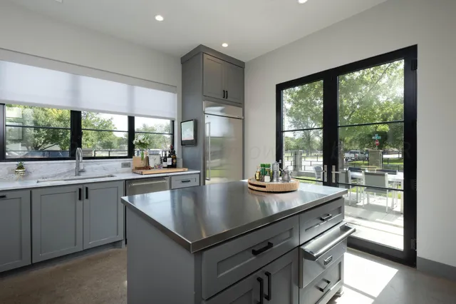 a bedroom with bed and a painting on the wall