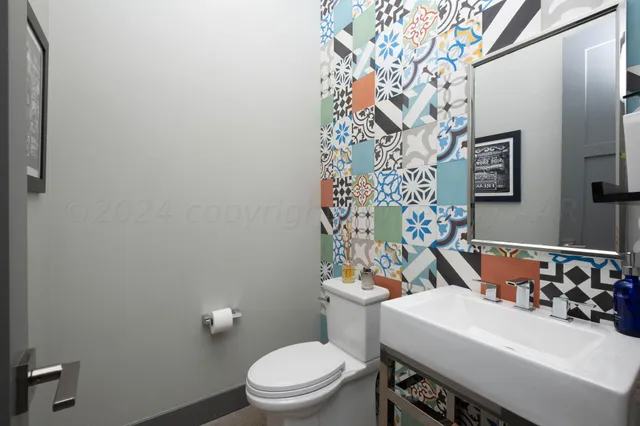 a bathroom with a tub a sink and a mirror