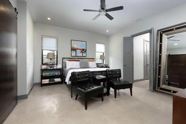 a bedroom with bed and a workspace