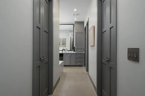 a kitchen with a refrigerator and a stove top oven