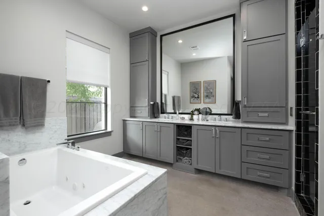 a bathroom with a double vanity sink a mirror and shower