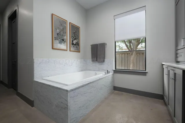 a living room with furniture and a book shelf