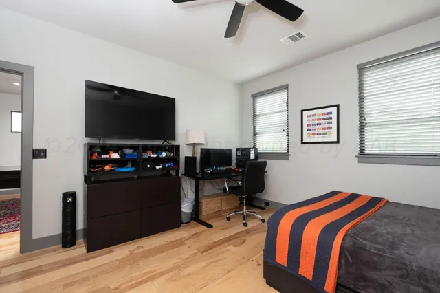 a bedroom with a bed and a view of backyard