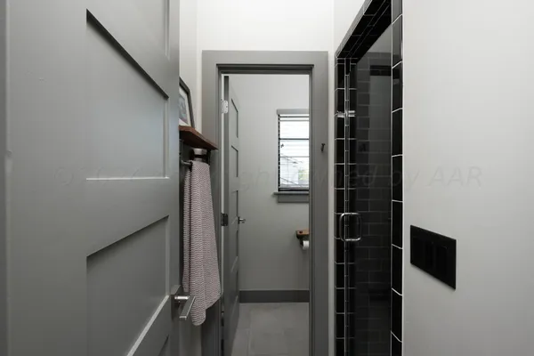 a view of a hallway with wooden shelves