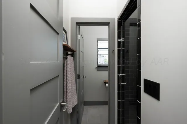 a view of a hallway with wooden shelves