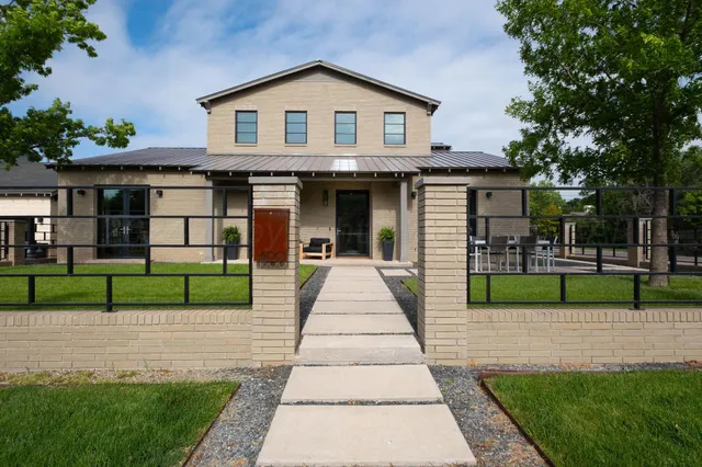 a view of a backyard with a patio and dining space