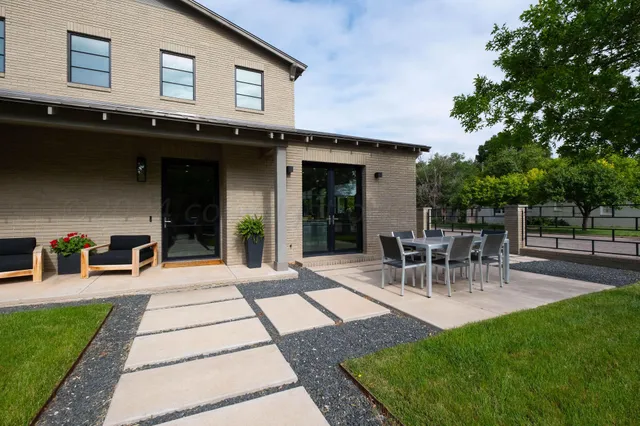 a building outdoor space with patio furniture and potted plants