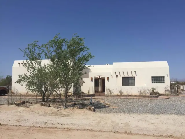 a white house that has a tree in it