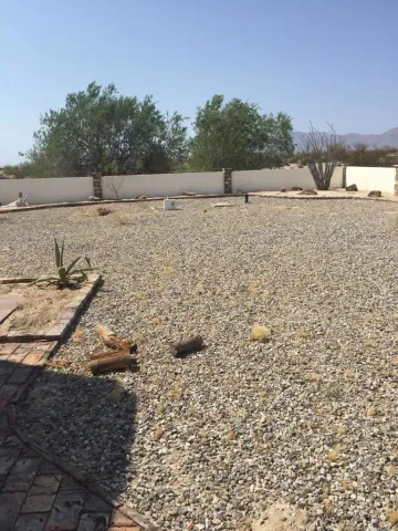 a view of a dry yard with a barn