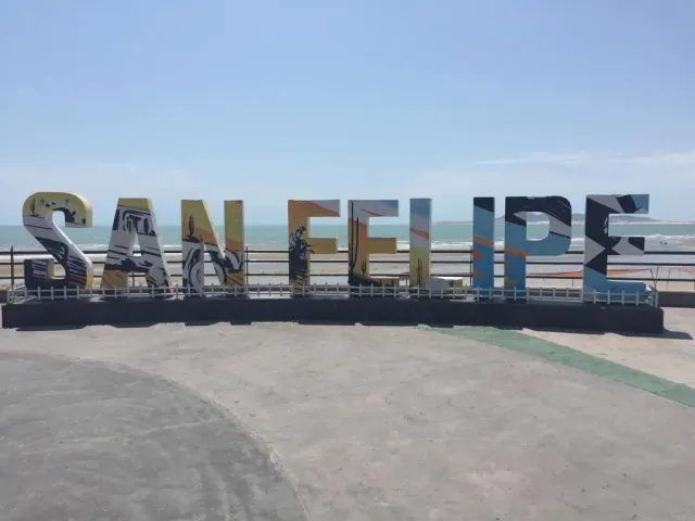 a swimming pool with outdoor seating and city view