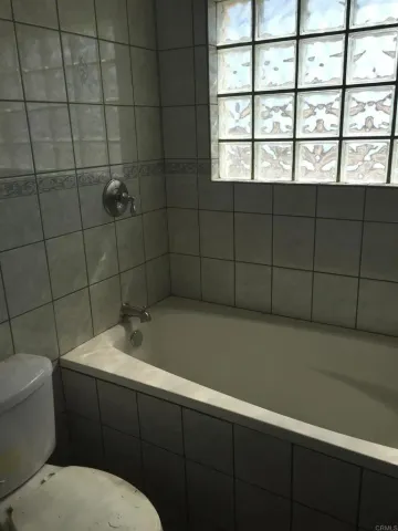 a bathroom with a toilet and a window